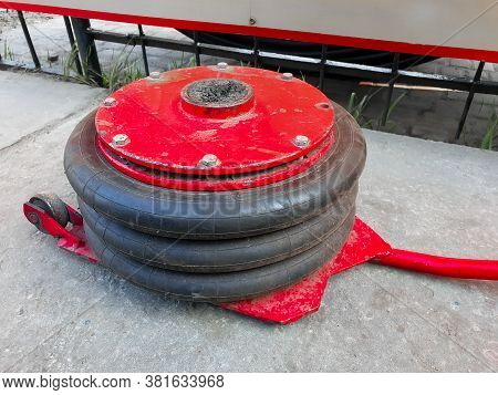 Tire. A Krast-ing Pneumatic Jack On The Ground. Close-up