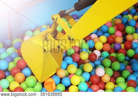 Yellow Escavator And Colorful Plastic Balls On Children's Playground, Toys