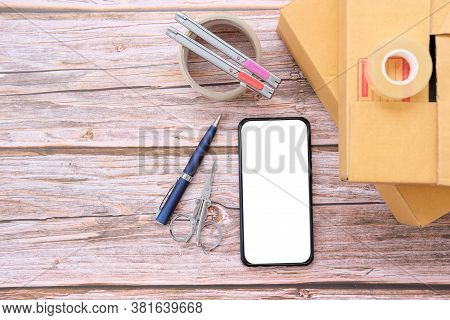 Delivery Box On Wood Table Background. Online Selling \nconcept