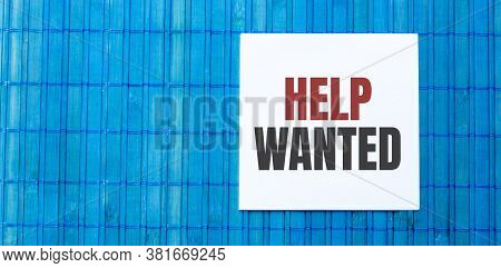 Blank Note Pad With Help Wanted Text On Green Wooden Background