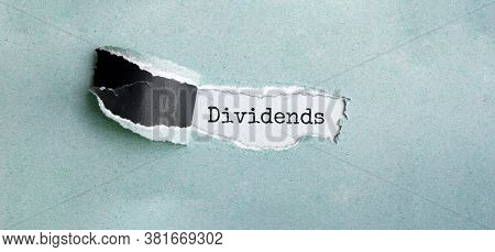 Dividends Appearing Behind Torn Brown Paper, Business Concept