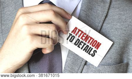 Businessman Holding A Card With Text Attention To Details