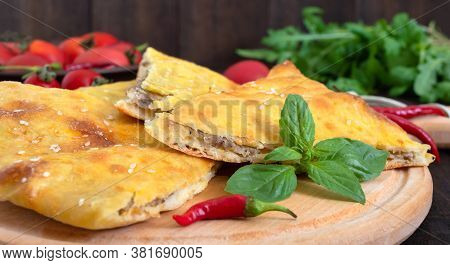 Kubdari Is A Meat Pie. Georgian Flatbread On A Wooden Board.