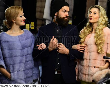 Friends In Shop: Ladies And Gentleman In Expensive Overcoats.