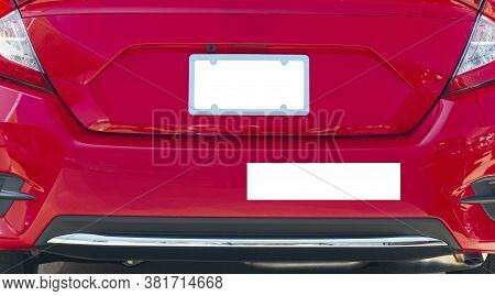 Horizontal Shot Of The Rear Of A Red Car With A Blank White License Plate And Bumper Sticker.  Good 