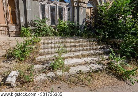 An Old Open Outer Stone Staircase. Stone, Cement Steps Of The Old Staircase With Traces Of Weatherin