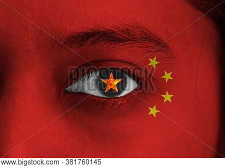 Human Face Painted China Flag With Yellow Star On The Center Of Eye Or Eyeball. Human Eye Painted Wi