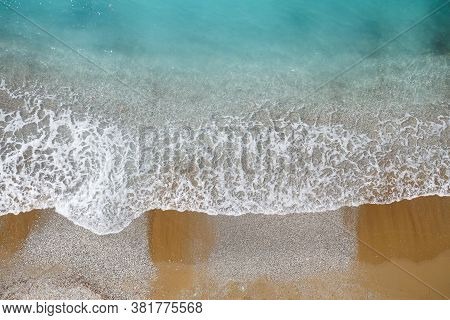 Top View Of The Sea Shore With Azure Water And A Sandy Beach. Aerial View Of The Middle Earth Sea Wi