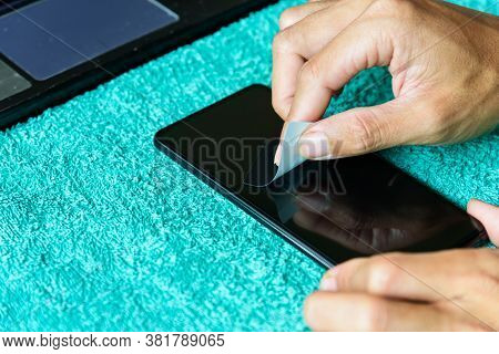 Cleaning Mobile Phone Screen By Adhesive Clear Tape. Before Apply The Smart Phone Screen Protect Fli
