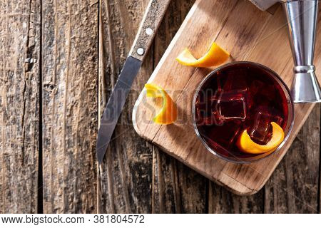 Boulevardier Cocktail And Orange Zest On Wooden Table.top View. Copy Space