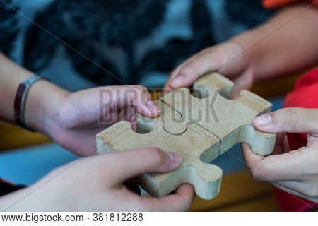 Businesswoman Hand Of Teamwork Holding Jigsaw Puzzle Connecting, Business Team Work Of Solutions In 