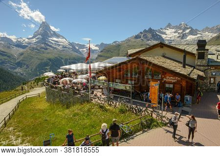 People Eating On The Restaurant Of Sunnegga Over Zermatt In The Swiss Alps