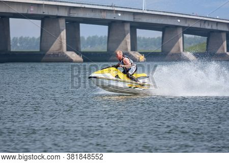 Lelystad, The Netherlands- May 01, 2009: Man Having Fun On Jet Ski Near Dutch Ketel Bridge