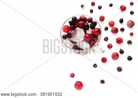 Frozen Berries With Ice In The Mug On A White Background.