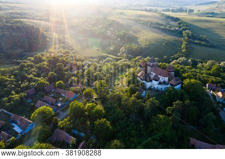 Viscri Fortified Church in Transylvania, Romania built as a stronghold fortification by the Saxons - aerial view.