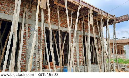 Wooden Poles Under Rcc Roof On Construction Site In India