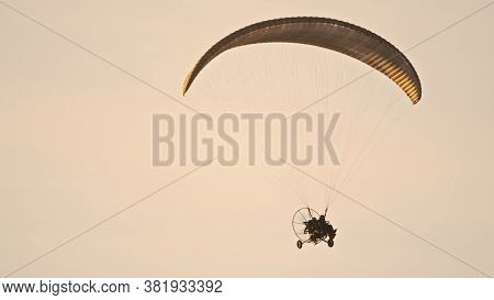Paramotor Tandem Gliding And Flying In The Air. Copy Space. High Quality Photo