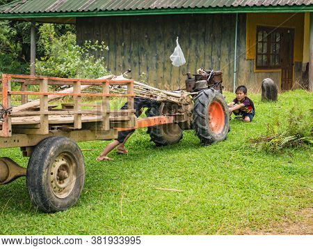 Vangvieng/lao-10 Dec 2017:unacquainted Local Child Playing With Tractor At Tham Chang Cave Vangvieng
