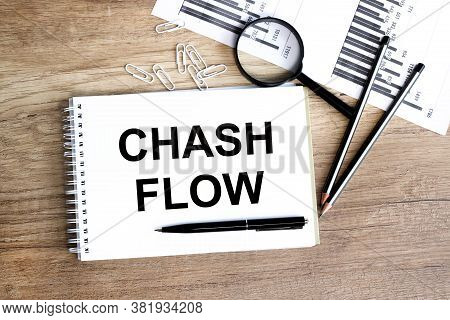 Chash Flow. Text On White Paper On A Nineteen Table. Near A Calculator, Pencils, Financial Charts