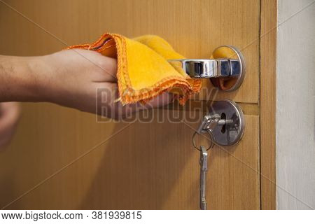 Cleaning The Door Handle For Coronavirus Prevention During Normal New Quarantine