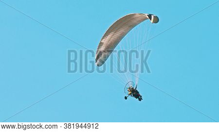 Paramotor Tandem Gliding And Flying In The Air. Copy Space. High Quality Photo