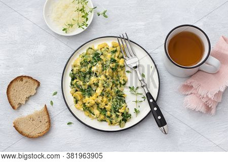 Scrumble Eggs With Kale And Cheese On A Light Gray Background, Top View. Delicious Homemade Breakfas