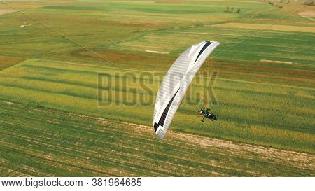Paramotor Tandem Gliding And Flying In The Air. Copy Space. High Quality Photo