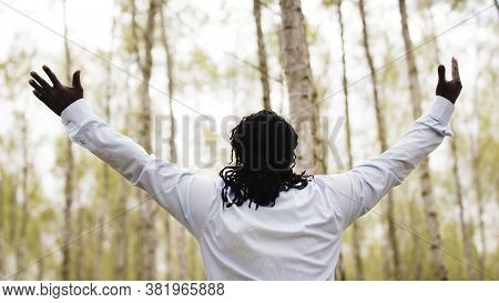 Black Lives Metters. African Businessman With Outstretche Hands Praying In The Park. High Quality Ph