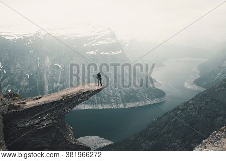 Woman On Trolltunga (Troll tongue) The Famous place in Norway, View On  Trolltunga And  Mountain Landscape, Odda, Norway