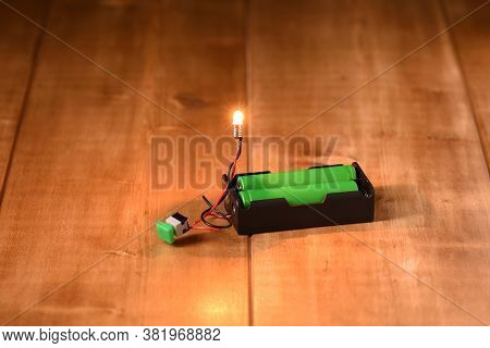 Small Filament Bulb Glows From Li Ion Batteries.
