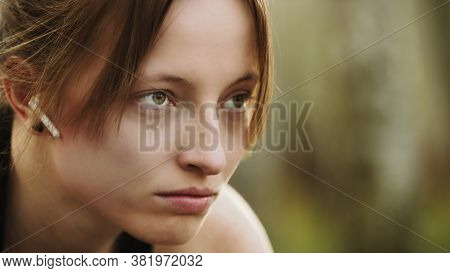 Portrait Of Young Athlete Woman In Start Position With Earphones. High Quality Photo