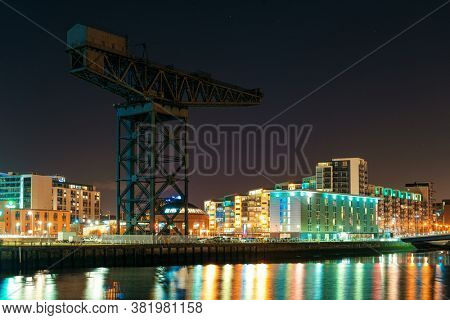 GLASGOW, UK - FEB 26, 2020: The Finnieston Crane or Stobcross Crane stand at waterfront of city center in Scotland, United Kingdom as the symbol of engineering heritage