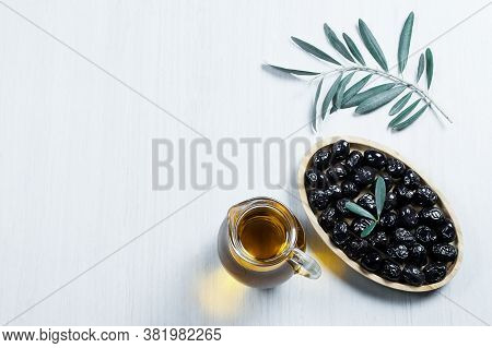 Glass Bottle Of Homemade Olive Oil And Olive Tree Branch, Raw Turkish Black Olive Seeds And Leaves O