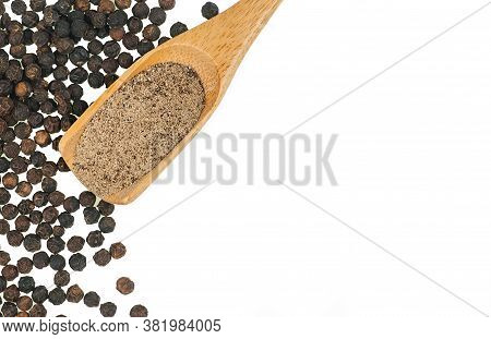 Close Up Heap Of Black Pepper In Wooden Spoon, Peppercorns And Milled Pepper Powder Isolated On Whit