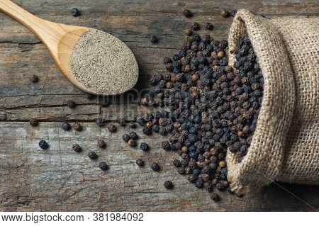 Heap Of Black Pepper And Black Pepper Powder, Milled Peppercorns On Wooden Background, Dried Spice P