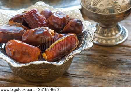 Ramadan Palm Fruit Dates In Silver Bowl And Zam Zam Water Symbolize Sacred Month For Muslims. Ramada