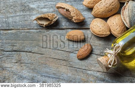 Sweet Almond Oil In Glass Of Bottle. Almonds Nuts And Oil Concept.great For Skin Health.almond In Nu