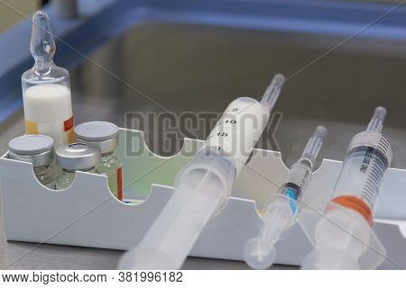 A White Anesthetic Drug In Syringe And Medications On The Table In Operating Room