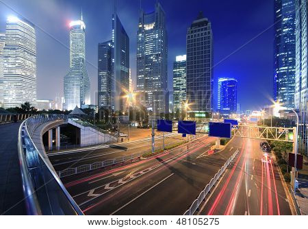 View Traffic Through Modern City At Night In Shanghai