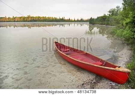 Red Canoe On Lake