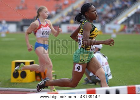 DONETSK, UKRAINE - JULY 11: Yanique Thompson, Jamaica (right) and Sokolova, Russia compete in semi-final of 100 m hurdles during 8th IAAF World Youth Championships in Donetsk, Ukraine on July 11, 2013