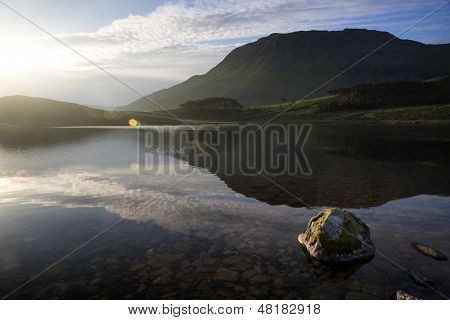 Beautiful Sunrise Mountain Landscape Reflected In Calm Lake