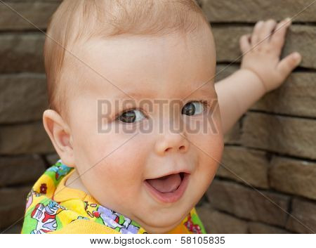 Smiling Baby Lean On Brick Wall