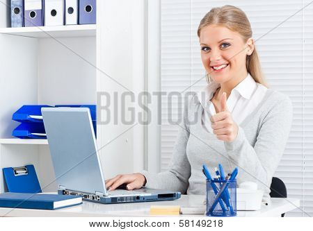 Businesswoman showing thumbs up