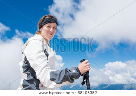 Young Woman Holding Trekking Pole In Her Hand
