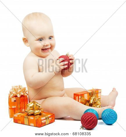 Rapt child holds red christmas ball, festive boxes