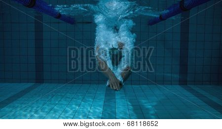 Fit swimmer training on his own in the swimming pool at the leisure centre