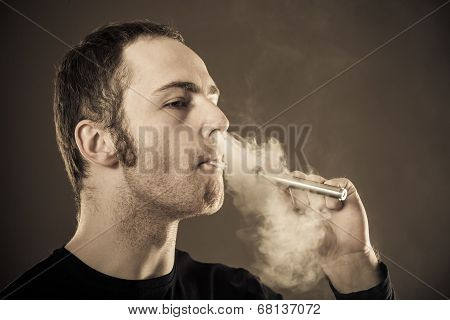 Man smokes electronic cigarette