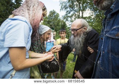 KRASNY BRONEVIK, RUSSIA - JULY 7, 2014: Celebrations commemorating the Rev. Anthony Dymsky (died 1224) in Antony Dymsky Monastery - Procession on Lake Dymsky, the great blessing of water and bathing.