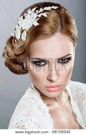 Portrait of a beautiful blonde woman in a wedding dress in the image of the bride.